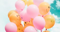 low-angle photo of pink and orange balloons